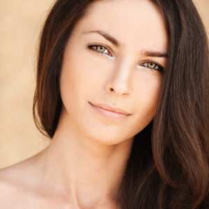 Woman with long brown hair gazing forward