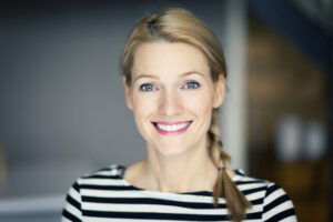 Mature woman with braided blonde hair smiling