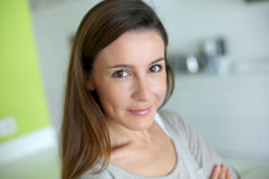 Woman with long brown hair smiling