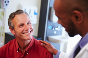 Patient and doctor smiling and having a conversation