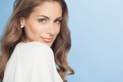 Woman with long brown hair looking back over her shoulder