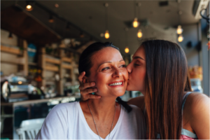 daughter kissing her mother on the cheek