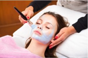Woman receiving a facial mask treatment