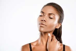 Serene woman with eyes closed touching her neck