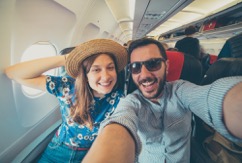 Couple on a plane smiling