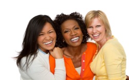 Group of three women smiling and posing together