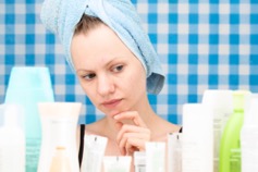 Woman trying to decide between different skin care products