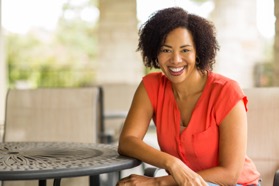 Woman smiling and sitting at a table