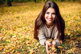 woman laying in grass and leaves