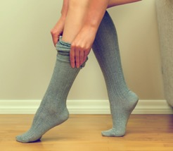 Woman putting socks on