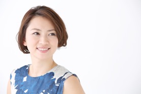 Woman smiling and wearing a blue and white shirt