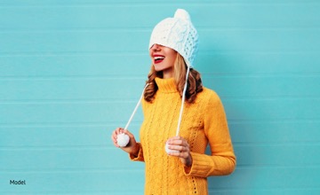 Girl pulling hat over her head