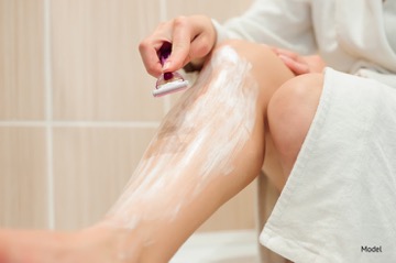 Person shaving their legs