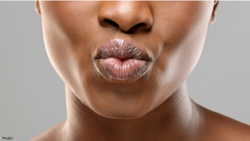 Close up of woman pouting lips