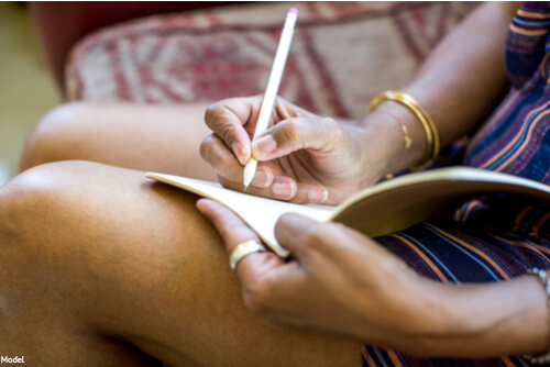 Person writing in a book