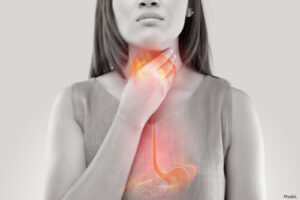 woman with acid reflux holding her throat