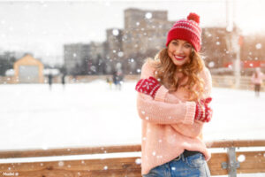 Woman wearing a sweater outside in the snow