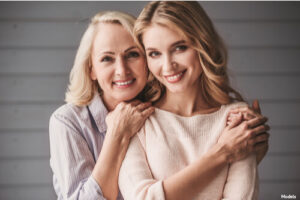 Mother and daughter smiling and posing together