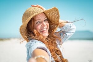 woman on the beach in a sun hat