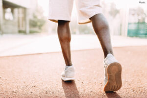 person wearing shorts and white shoes