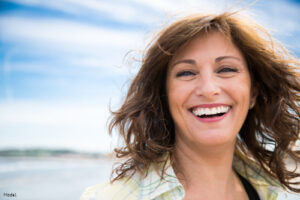 Mature woman with short brown hair smiling