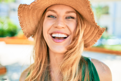 Joyful woman smiling in a straw hat