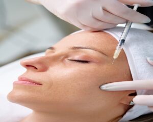 Close-up of young woman receiving Botox injection at beauty clinic for wrinkle smoothing and facial rejuvenation treatment